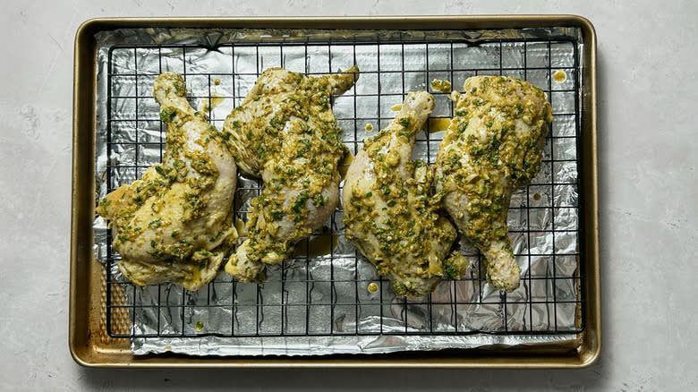 Marinated uncooked mojo chicken on sheet pan 