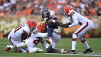 Chicago Bears quarterback Justin Fields, second from right, slides for a short gain against Cleveland Browns defensive end Joe Jackson (91), linebacker Jeremiah Owusu-Koramoah (28) and cornerback Denzel Ward (21) during the second half of an NFL football game against the Cleveland Browns, Sunday, Sept. 26, 2021, in Cleveland. (AP Photo/David Dermer)