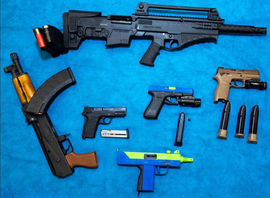 Police said these firearms were seized Friday in the search of a convicted felon's home in Athens.