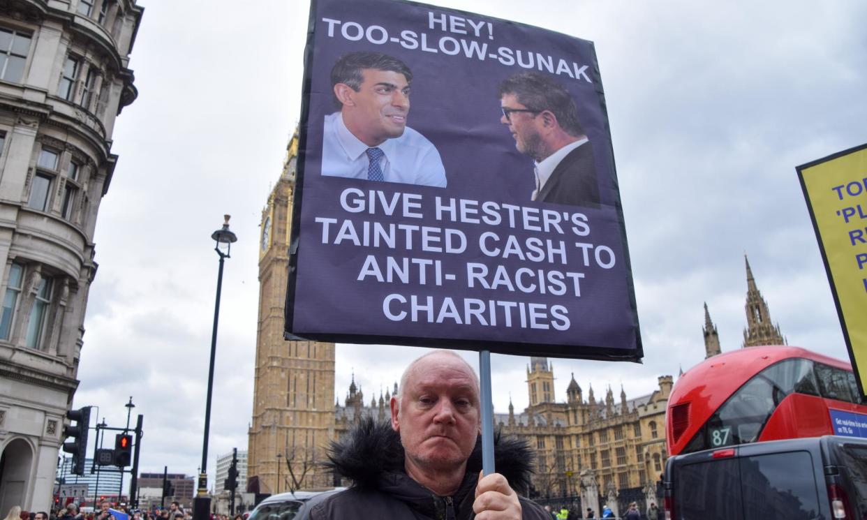 <span>A protester in Parliament Square holds a placard referencing the row about Hester’s remarks and his donation to the Tory party.</span><span>Photograph: Vuk Valcic/Zuma Press Wire/Rex/Shutterstock</span>