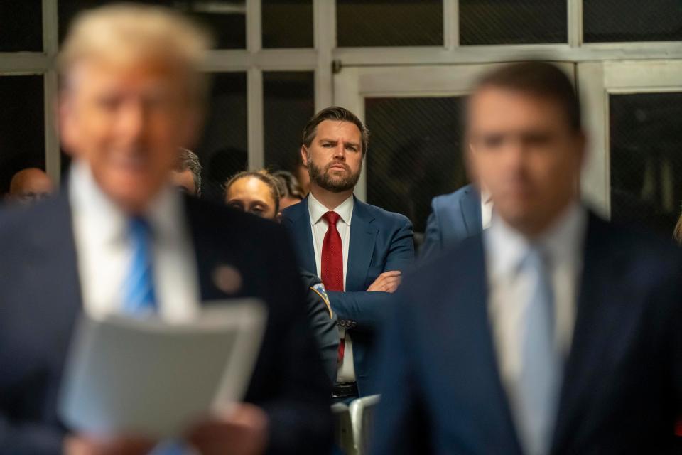 Sen. J.D. Vance listens to former President Donald Trump outside the Manhattan Criminal Court during Trump's hush money trial in May.