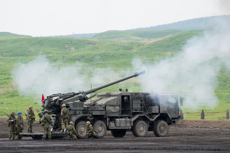 日本防衛省擬升級駐守沖繩的陸上自衛隊第 15 旅團。圖為自衛隊19式155公厘輪型自走砲實彈射擊演訓畫面。   圖：翻攝陸上自衛隊推特