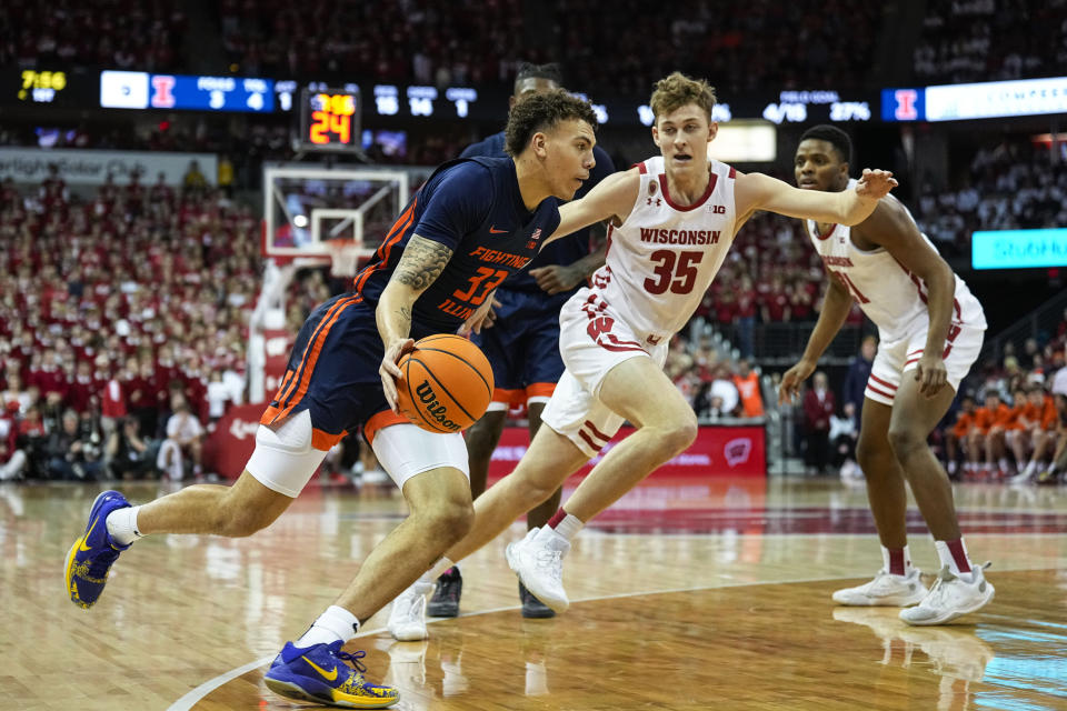 Illinois's Coleman Hawkins (33) maneuvers around Wisconsin's Markus Ilver (35) during the first half of an NCAA college basketball game, Saturday, Jan. 28, 2023, in Madison, Wis. (AP Photo/Andy Manis)