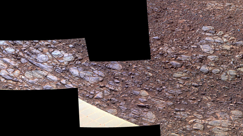 This October 2017 photo made available by NASA shows an enhanced-color view of ground sloping downward to the right in "Perseverance Valley," seen by the Opportunity rover on Mars. The textures may be due to abrasion by wind-driven sand. (NASA/JPL-Caltech/Cornell University/Arizona State University via AP)
