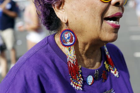 Lucrecia Fontes, of San Francisco, displays her Grateful Dead-themed jewelry outside Levi's Stadium before Grateful Dead's "Fare Thee Well: Celebrating 50 Years of Grateful Dead" farewell tour in Santa Clara, California June 27, 2015. REUTERS/Stephen Lam