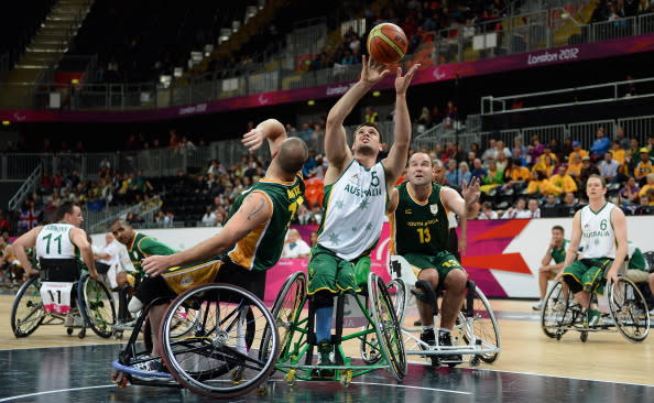 Bill Latham of Australia shoots while under pressure from Richard Nortje and Stuart Jellows of South Africa during the Group A Preliminary Men's Wheelchair Basketball match between Australia and South Africa on day 1 of the London 2012 Paralympic Games at Basketball Arena on August 30, 2012 in London, England. (Photo by Christopher Lee/Getty Images)