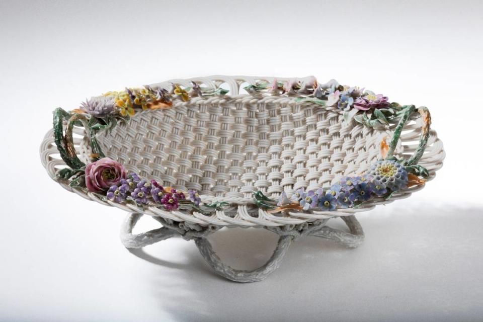 Ott and Brewer (Trenton, N.J., 1871-93). Basket, circa 1885, Belleek porcelain, tinted gray, polychrome enamels. This is in the Mint Museum Randolph’s exhibit “Walter Scott Lenox and American Belleek,” featuring 80 porcelain works from notable public and private collections, and the Mint’s permanent collection.