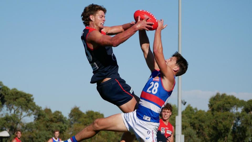 Assignment Freelance Picture MELBOURNE, AUSTRALIA - NewsWire Photos MARCH 30, 2024: Tom Fullarton\n and Anthony Scott compete for the ball during the VFL Round 2 match between\n Casey Demons and Footscray Bulldogs at Casey Fields. Picture: NCA\n NewsWire/Blair Jackson