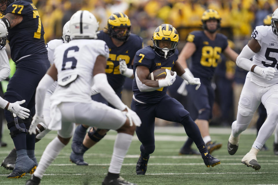 FILE - Michigan running back Donovan Edwards (7) rush the ball against Penn State in the first half of an NCAA college football game in Ann Arbor, Mich., Saturday, Oct. 15, 2022. No. 2 Michigan brings its smash-mouth ways into the College Football Playoff semifinal on Saturday, Dec. 31, 2022 to face No. 3 TCU. (AP Photo/Paul Sancya, File)