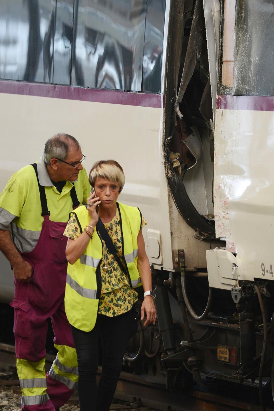 Workers stand by the train