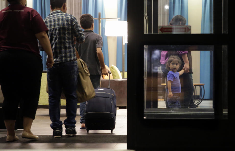 FILE - Immigrants seeking asylum who were recently reunited arrive at a hotel in San Antonio, July 23, 2018. The Biden administration is asking that parents of children separated at the U.S.-Mexico border undergo another round of psychological evaluations in an effort to measure how just traumatized they were by the Trump-era policy, court documents show. (AP Photo/Eric Gay, File)