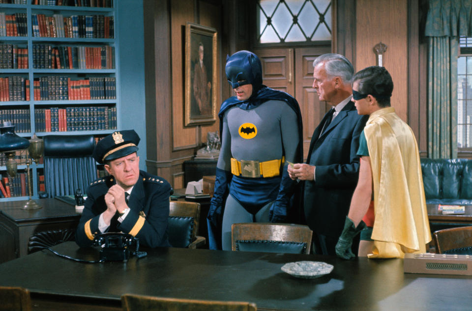 (Original Caption) Left to right: Stafford Repp, Chief of Police; Adam West as Batman; Neil Hamilton as Commissioner and Burt Ward as Robin in a scene from The Bookworm episode in the Batman TV series.