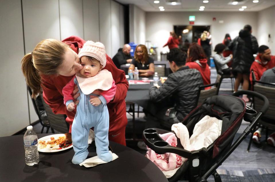 USC women's basketball head coach Lindsay Gottlieb kisses her daughter Reese during a team dinner while on the road.