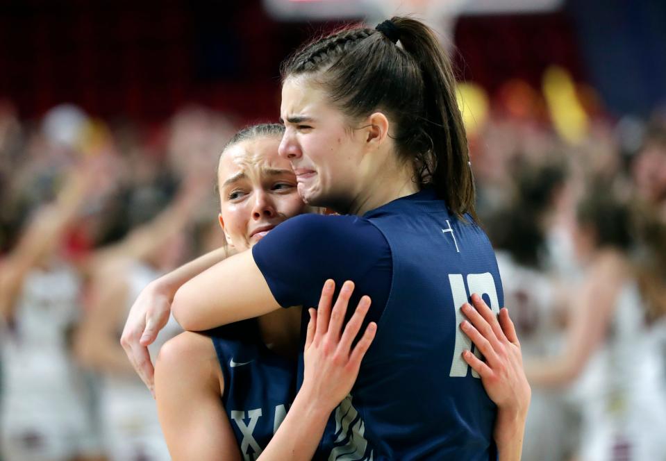 Xavier's Carsyn Stempa, left, and Halle Vande Hey console each other in a loss to Madison Edgewood during their WIAA Division 3 girls basketball championship game Saturday at the Resch Center in Ashwaubenon.