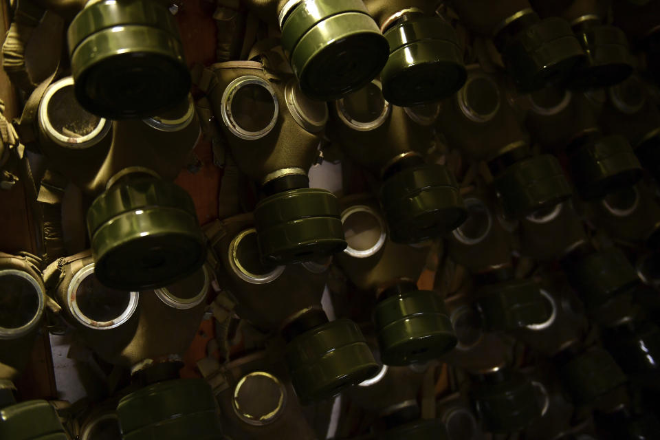 FILE - Gas masks hang on the wall at the Rock Nuclear Bunker Museum in Budapest, Hungary, Friday, Oct. 14, 2022. Fighting around Ukraine's nuclear power plants and Russia's threats to use nuclear weapons have reawakened nuclear fears in Europe. This is especially felt in countries near Ukraine, like Poland, where the government this month ordered an inventory of the country's shelters as a precaution. (AP Photo/Anna Szilagyi, File)