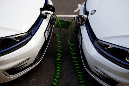 FILE PHOTO: Electric Volkswagen cars are plugged into a recharging point in London, Britain January 19, 2017. REUTERS/Stefan Wermuth/File Photo