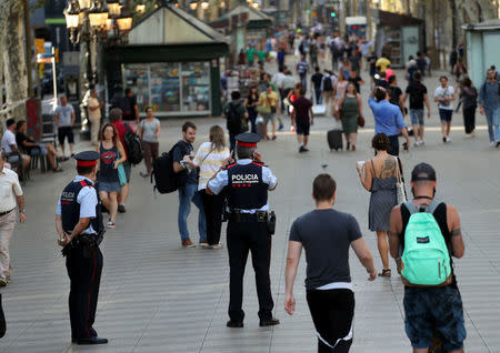 Catalan Mossos d'esquadra officers patrol at Las Ramblas street where a van crashed into pedestrians in Barcelona, Spain August 18, 2017. REUTERS/Sergio Perez