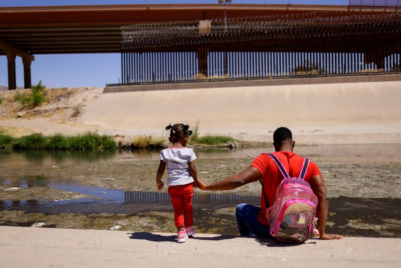 FILE PHOTO: Asylum-seeking migrants cross the Rio Bravo river in El Paso