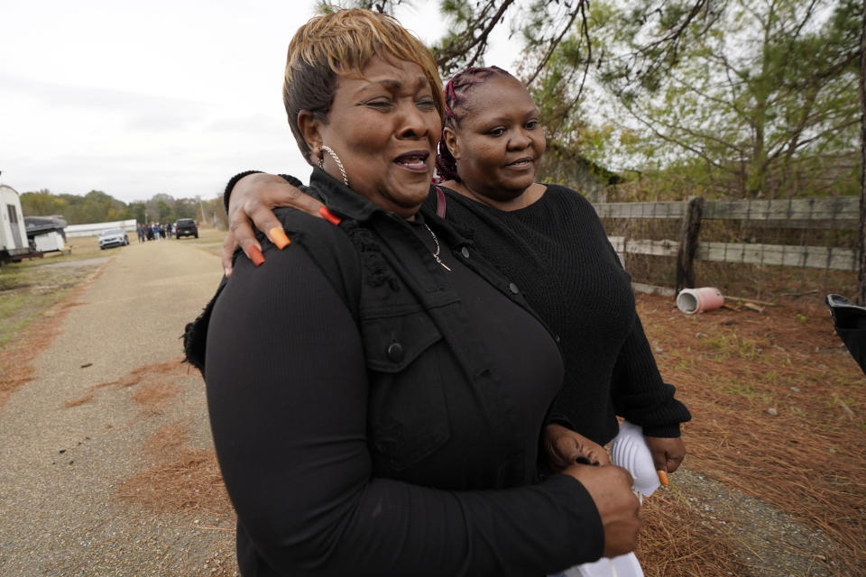 Bettersten Wade, left, mother of Dexter Wade, a 37-year-old man who died after being hit by a Jackson, Miss., police SUV driven by an off-duty officer, is comforted by her daughter, Latonya Moore, as they leave the Hinds County Penal Farm in Raymond, Miss., Monday, Nov. 13, 2023, after family members and media watched Wade's body transferred to a mortuary transport. Civil rights attorney Ben Crump said Monday he is asking for a federal investigation as to why authorities waited several months to notify the family of Wade's death. (AP Photo/Rogelio V. Solis)