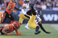 Pittsburgh Steelers free safety Minkah Fitzpatrick (39) is tripped by Cincinnati Bengals wide receiver Tyler Boyd (83) after making an interception during the first half of an NFL football game, Sunday, Nov. 28, 2021, in Cincinnati. (AP Photo/Aaron Doster)