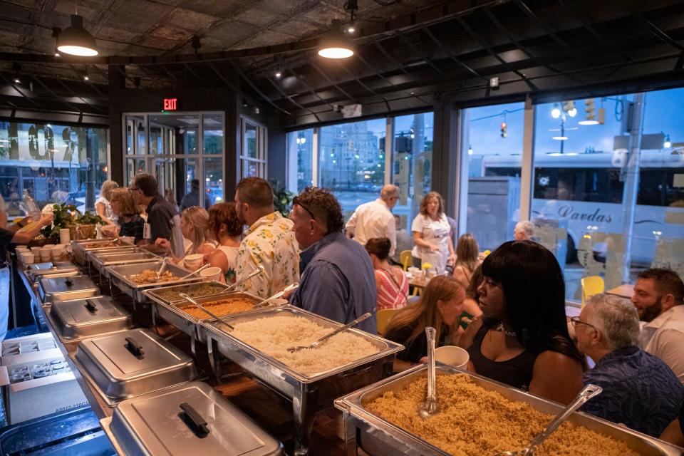 People try the food at Baobab Fare as part of the EAT Detroit restaurant experience in Detroit on Aug. 3, 2022. People tried 23 different restaurants throughout downtown area as part of the event.