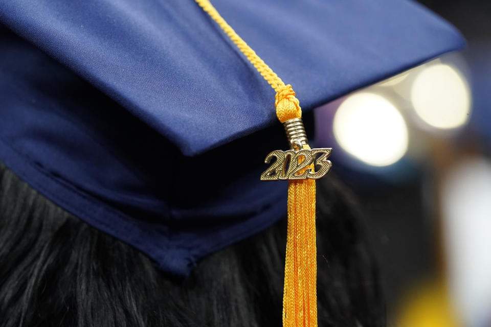FILE - A tassel with 2023 on it rests on a graduation cap as students walk in a procession for Howard University's commencement in Washington, Saturday, May 13, 2023. Two conservative groups are asking a federal court to block the Biden administration’s plan to cancel $39 billion in student loans for more than 800,000 borrowers. (AP Photo/Alex Brandon, File)