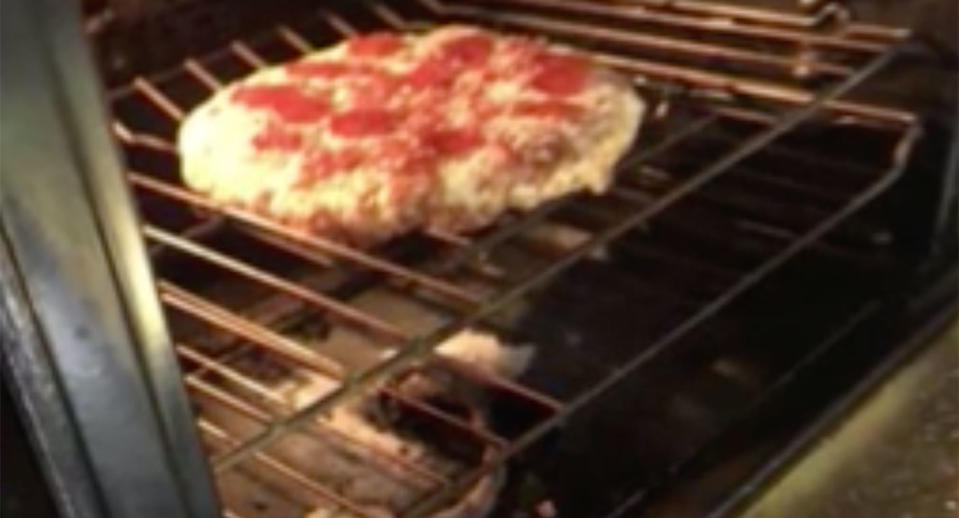 A pizza pictured in an oven.