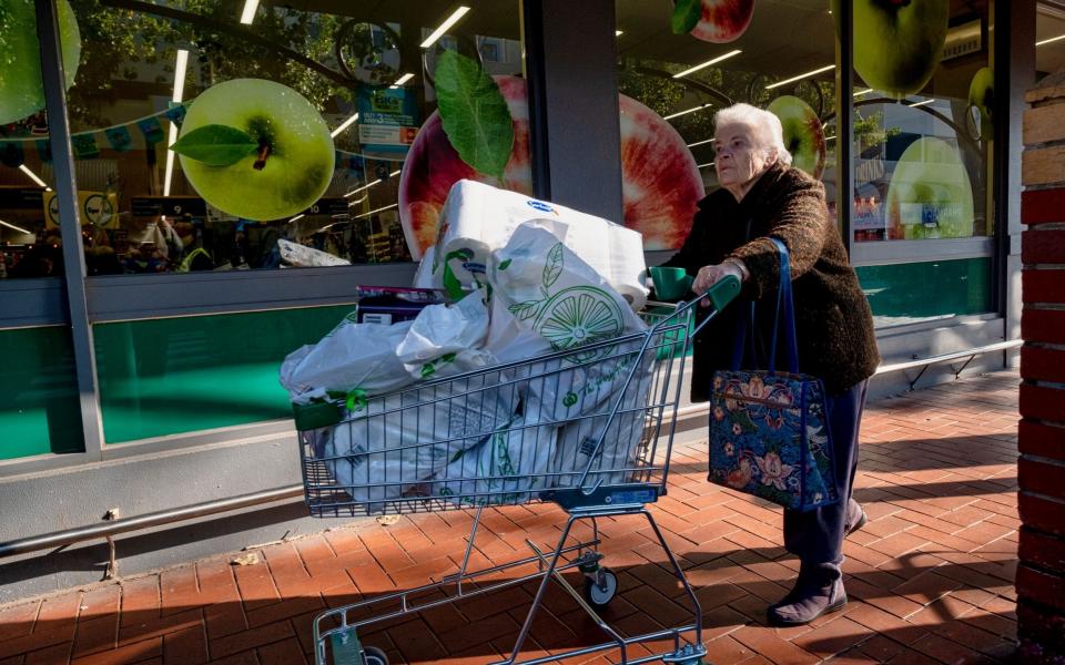 People continue to shop prior to the general lockdown in Melbourn - Shutterstock