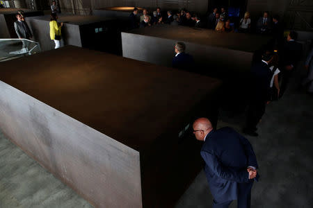 People look at dioramas contained inside iron boxes as part of the "S.A.C.R.E.D" installation by Chinese artist Ai Weiwei during a media preview at the cathedral in Cuenca, Spain, July 21, 2016. Picture taken July 21, 2016. REUTERS/Susana Vera