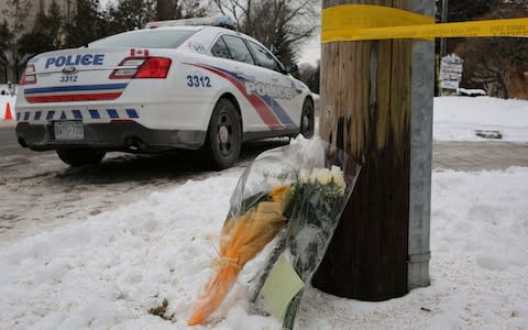 Flowers from mourners are seen outside the home of billionaire founder of Canadian pharmaceutical firm Apotex Inc., Barry Sherman and his wife Honey - Credit: Chris Helgren/Reuters