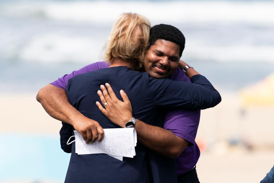 Anthony Bruce, a great-great grandson of Charles and Willa Bruce, is hugged by Los Angeles County supervisor Janice Hahn during a dedication ceremony in Manhattan Beach, California, Wednesday, July 20, 2022.