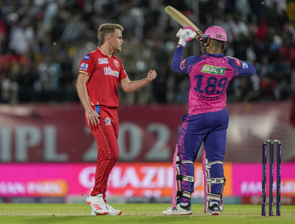 Punjab Kings' Sam Curran, left, reacts as Rajasthan Royals' Shimron Hetmyer asks for review after he was give out caught behind during the Indian Premier League cricket match between Punjab Kings and Rajasthan Royals in Dharamshala, India, Friday, May 19, 2023. (AP Photo /Ashwini Bhatia)