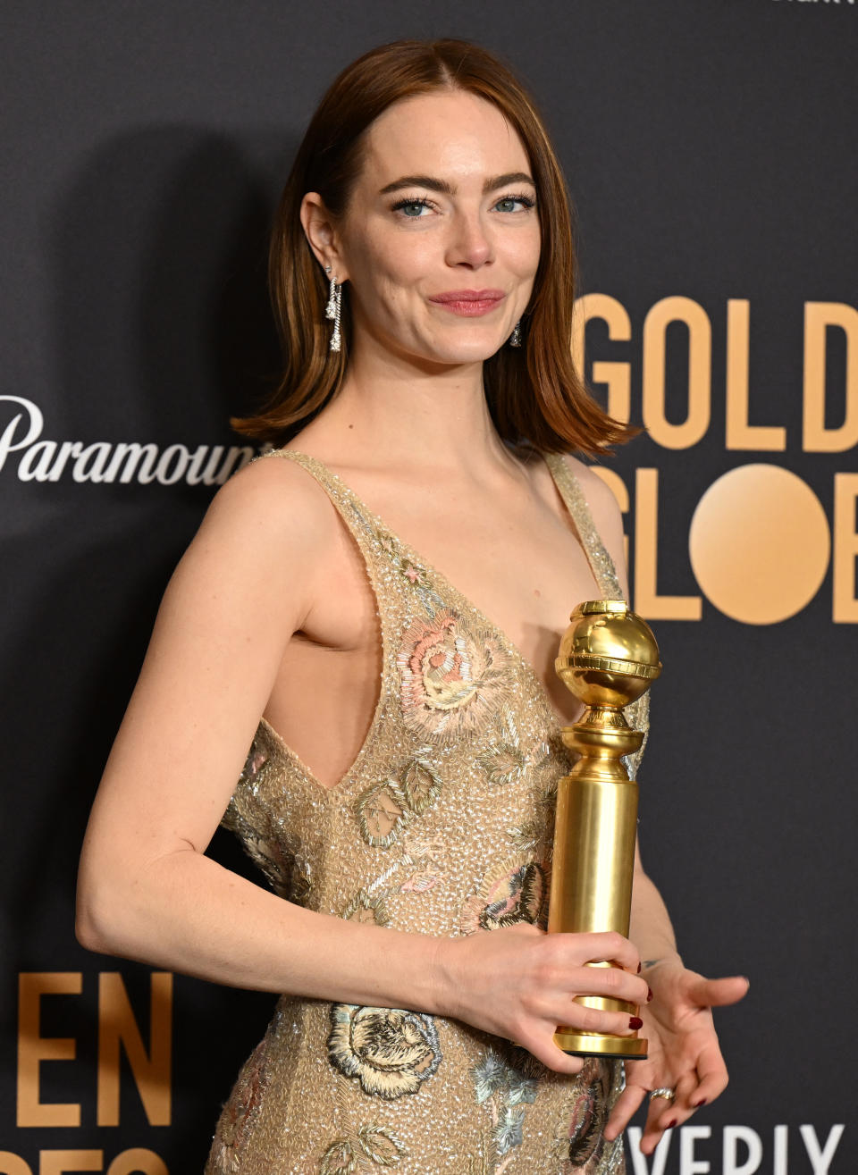 Close-up of Emma/Emily holding an award