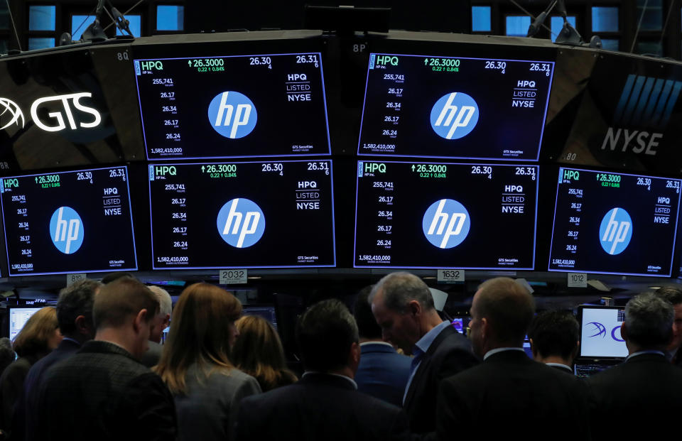 People gather at the post where Hewlett-Packard (HP) is traded on the floor of the New York Stock Exchange (NYSE) in New York, U.S., October 3, 2018. REUTERS/Brendan McDermid