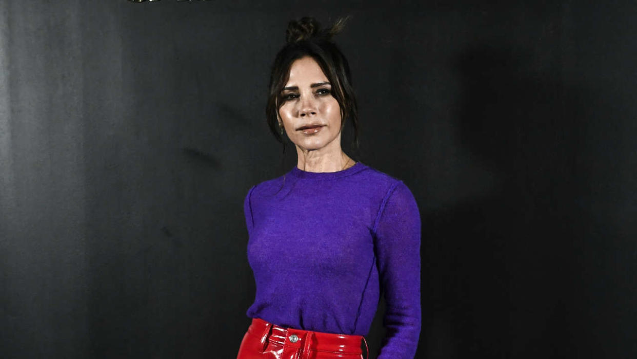 British singer and stylist Victoria Beckham poses for a photocall prior the Saint-Laurent Fall-Winter 2022-2023 collection fashion show during the Paris Womenswear Fashion Week, in Paris, on March 1, 2022. (Photo by STEPHANE DE SAKUTIN / AFP)