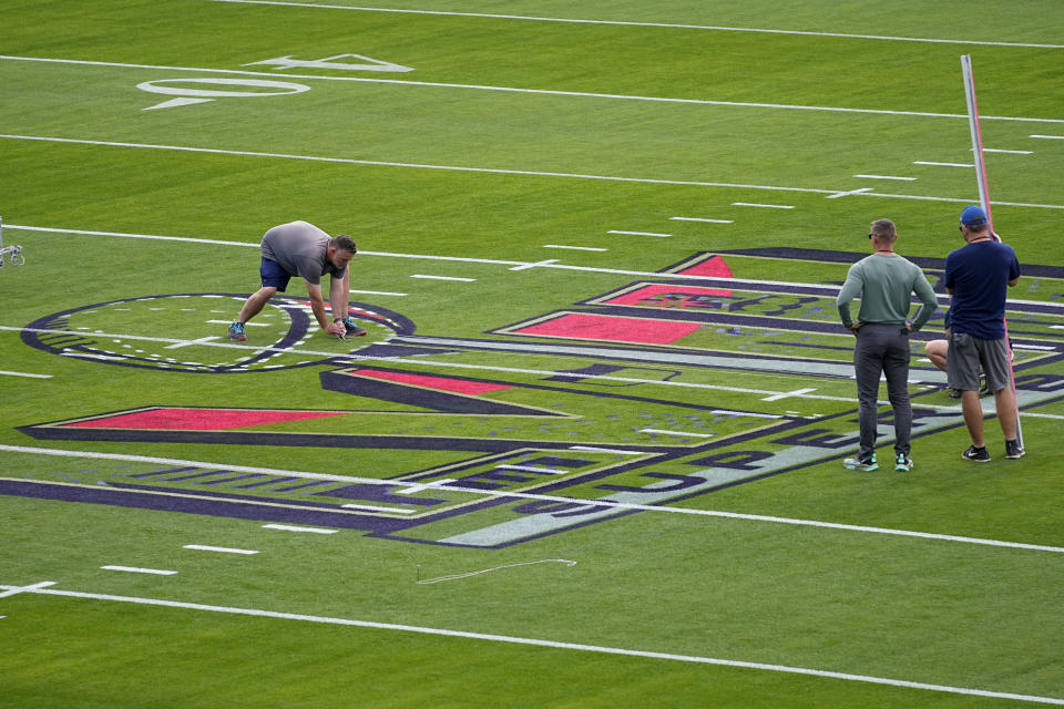 Workers prepare the field outside Allegiant Stadium ahead of Super Bowl 58, Wednesday, Jan. 31, 2024, in Las Vegas. (AP Photo/Matt York)