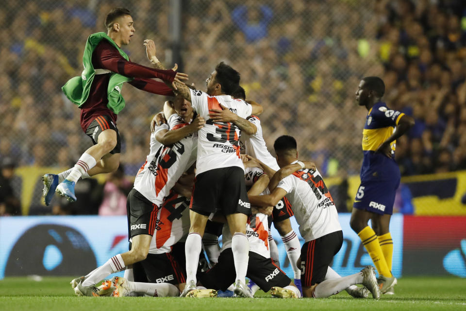 River Plate players celebrate qualifying for the final, at the end of their 0-1 loss to Boca Juniors in a Copa Libertadores semifinal second leg soccer match at La Bombonera stadium in Buenos Aires, Argentina, Tuesday, Oct. 22, 2019. River won 2-1 on aggregate and qualified to the final. (AP Photo/Natacha Pisarenko)