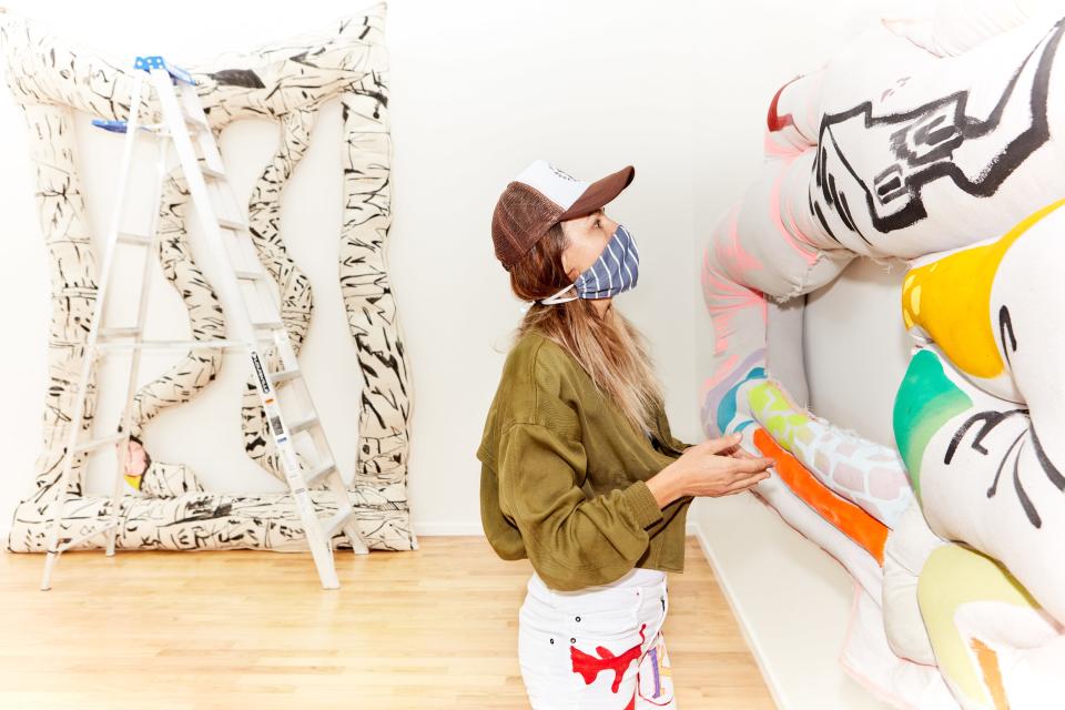 Lipke installing her work. Cole and Spengemann found the space on Broadway by calling a number listed on an empty storefront.