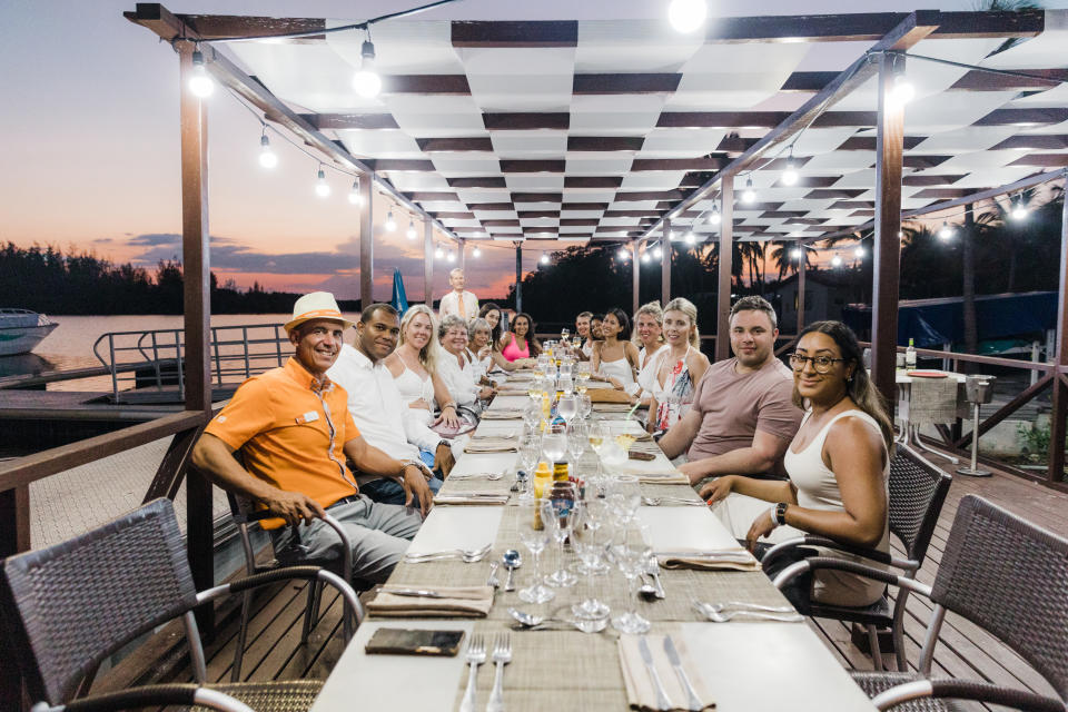 A group of happy travellers pose for a picture at dinner at a Sunwing resort in Cayo Largo, Cuba
