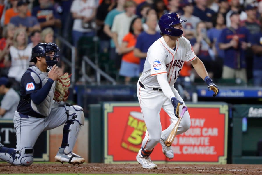 Houston Astros’ Joey Loperfido, right, flips his bat as he heads to first base on his two run RBI single in front of Cleveland Guardians catcher Bo Naylor, left, during the fourth inning of a baseball game Tuesday, April 30, 2024, in Houston. Loperfido’s hit was his first in the major leagues. (AP Photo/Michael Wyke)