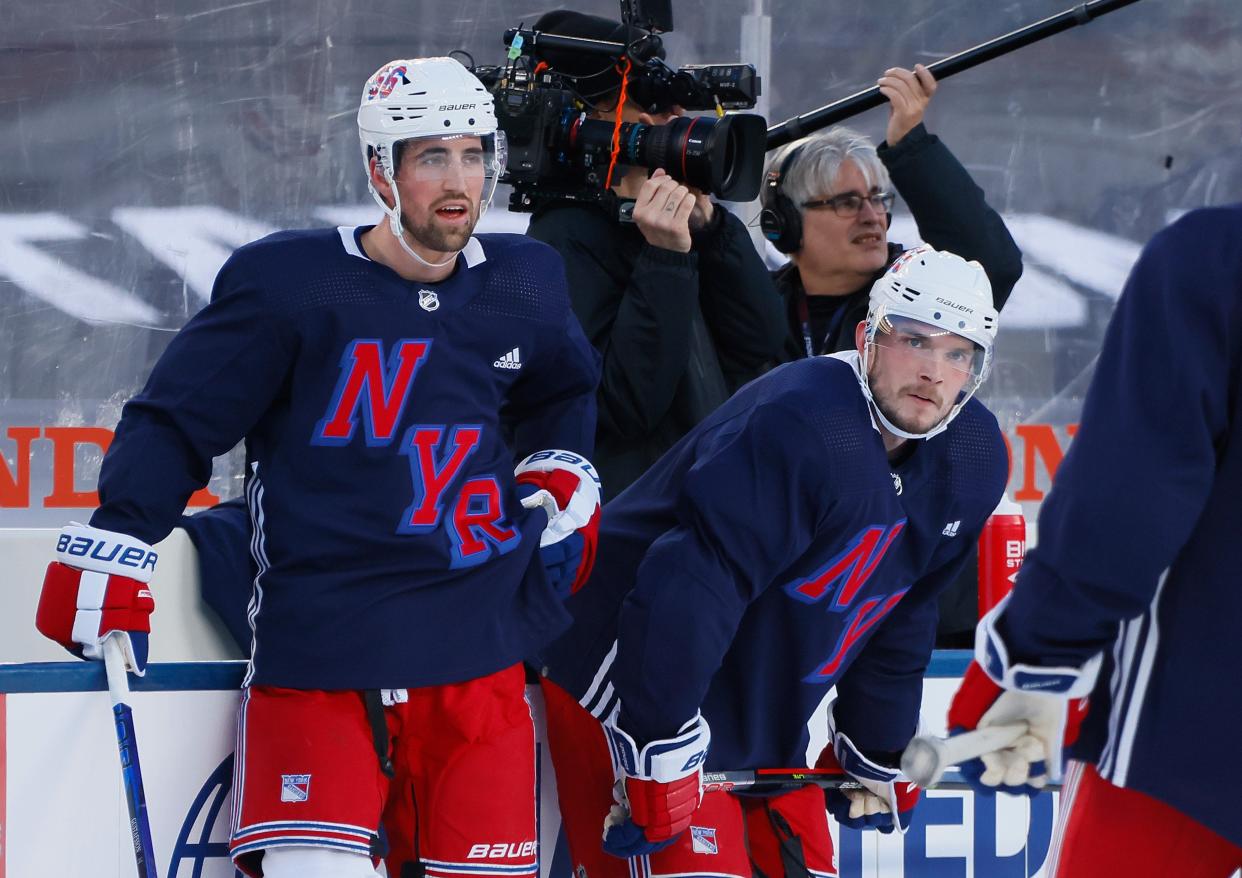 EAST RUTHERFORD, NEW JERSEY - FEBRUARY 16: Erik Gustafsson #56 and Ryan Lindgren #55 of the New York Rangers practice ahead of their Stadium Series game at MetLife Stadium on February 16, 2024 in East Rutherford, New Jersey.