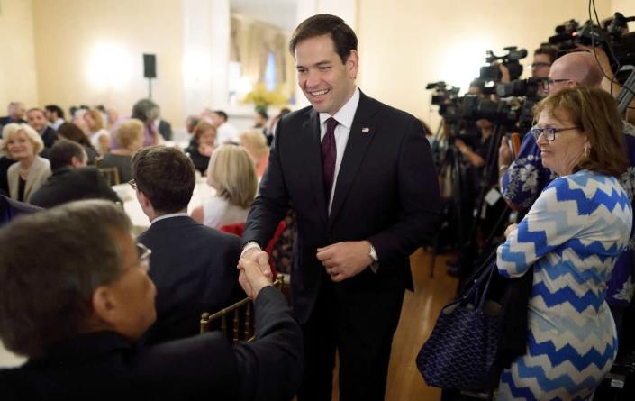 Senator Marco Rubio shakes hands as he leaves the Foreign Policy Initiative breakfast on August 14, 2015 in New York (AFP Photo/Don Emmert)