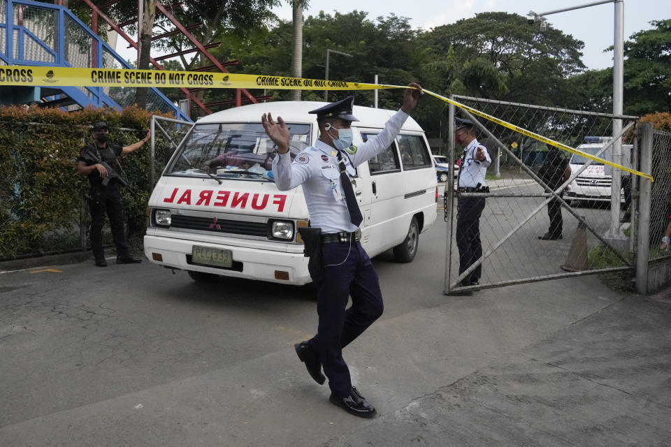 A vehicle carrying one of the dead victims exits the Ateneo de Manila University in Quezon city, Philippines, Sunday, July 24, 2022. At least three people, including a former Philippine town mayor, were killed and another was wounded in a brazen attack on Sunday by a gunman in a university campus in the capital region, officials said. (AP Photo/Aaron Favila)