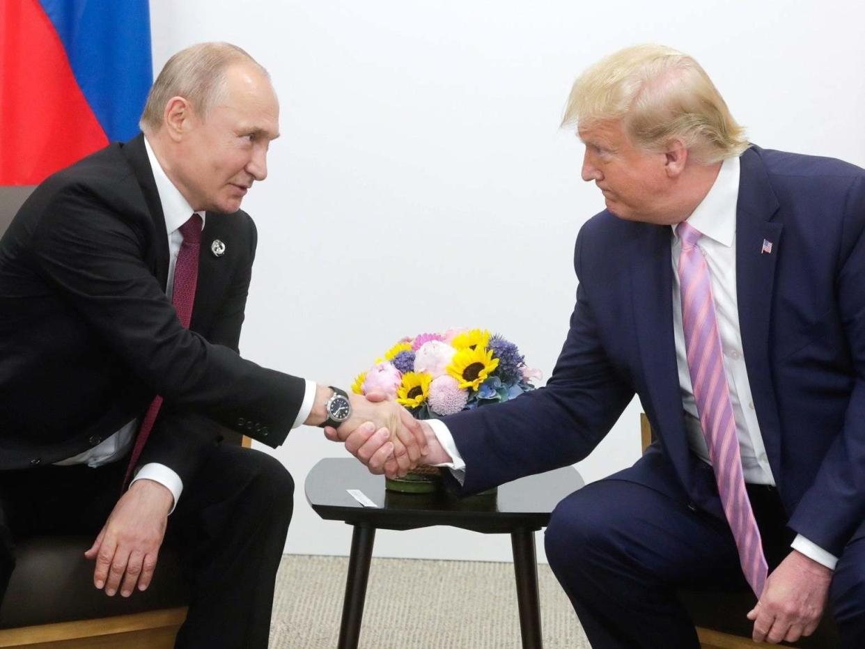 Vladimir Putin and Donald Trump shake hands at the G20 summit in Osaka, Japan: Kremlin Press Office/Getty