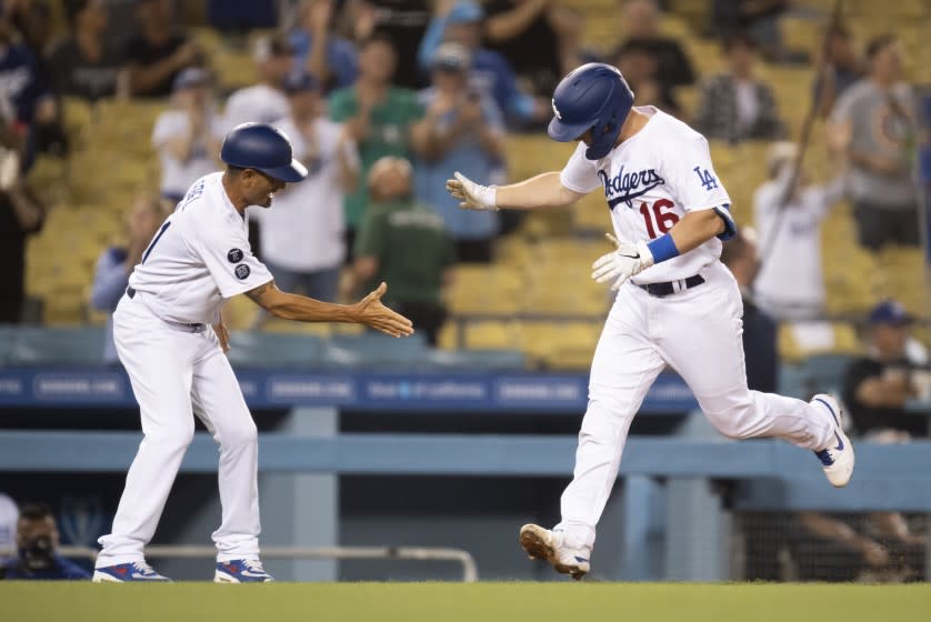 Los Angeles Dodgers' Will Smith, right, celebrates his two-run home run with third base coach Dino Ebel.