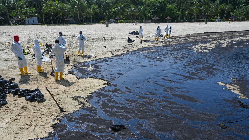 Oil covers Sentosa's Tanjong Beach in Singapore on June 16, 2024. - Roslan Rahman/AFP/Getty Images