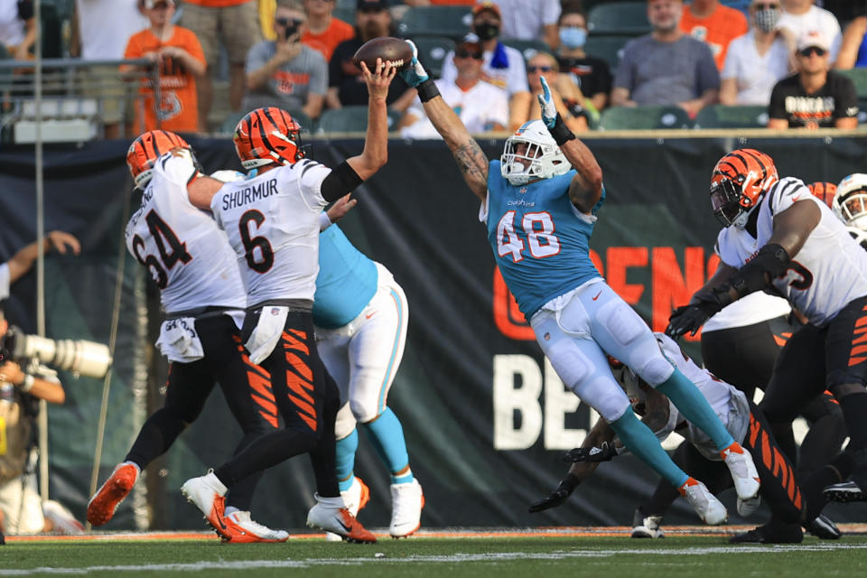 Miami Dolphins linebacker Calvin Munson (48) deflects a pass for a two-point conversion by Cincinnati Bengals quarterback Kyle Shurmur (6) in the second half of an NFL exhibition football game in Cincinnati, Sunday, Aug. 29, 2021. (AP Photo/Aaron Doster)