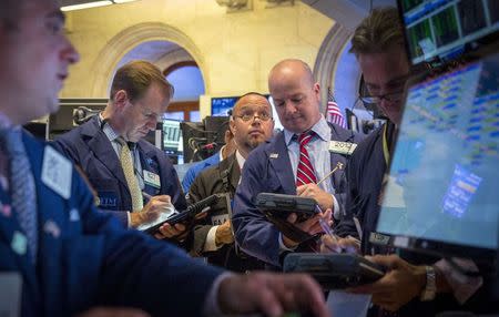 Traders work on the floor of the New York Stock Exchange August 19, 2014. REUTERS/Brendan McDermid