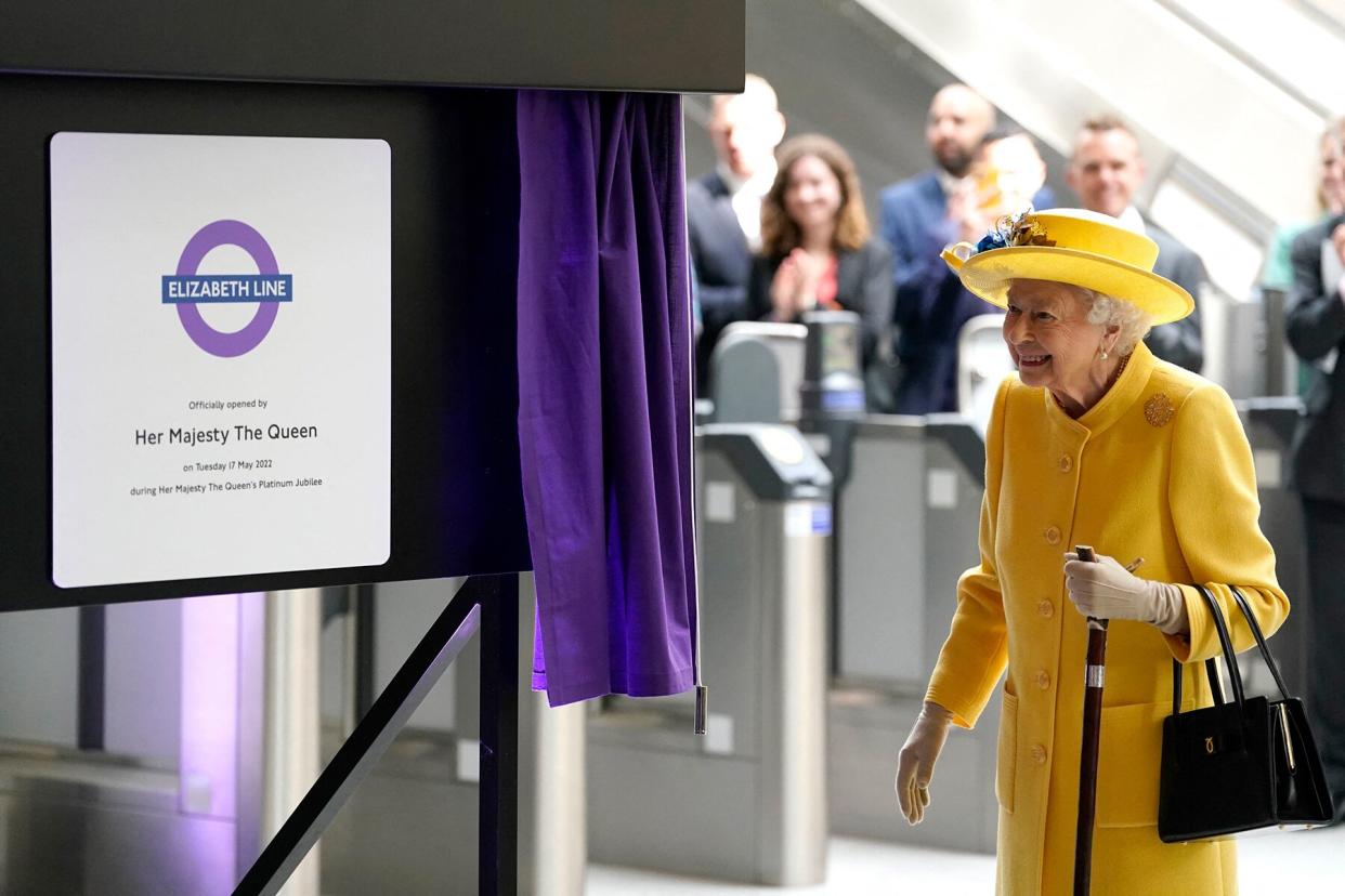 Britain's Queen Elizabeth II unveils a plaque to mark the official opening of the 'Elizabeth Line' rail service at Paddington Station in London