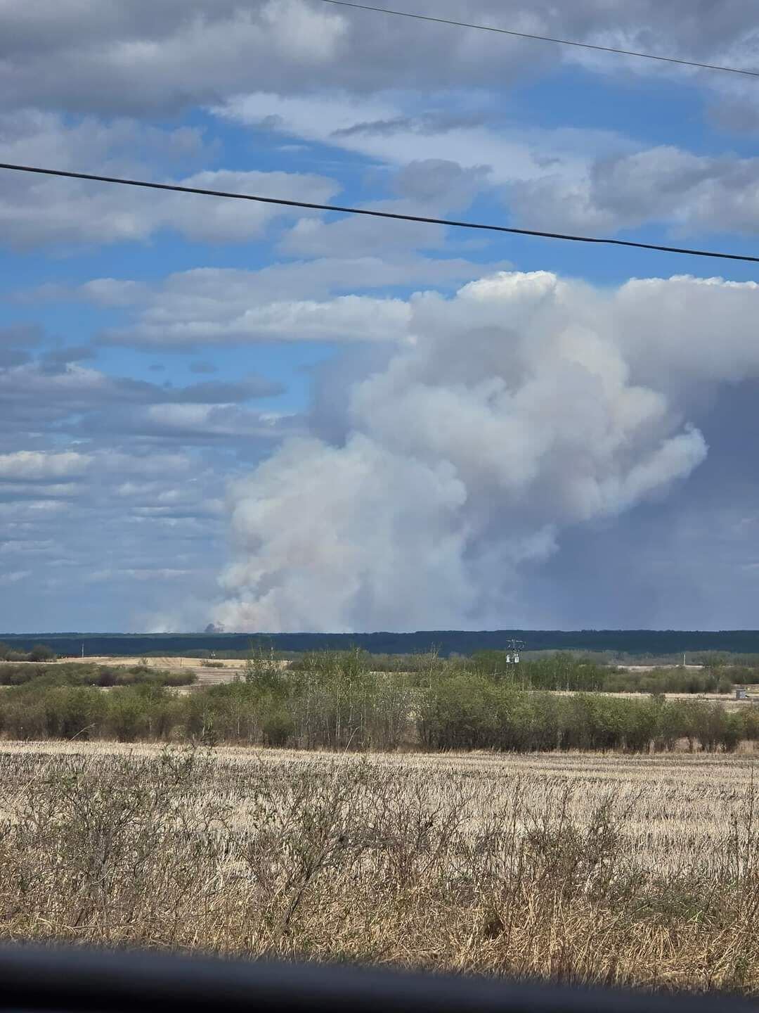 A wildfire near the Doig River First Nation is pictured from north of Fort St. John, B.C., on Monday. The fire led to an evacuation order for the entire community. (Submitted by Amber McGill - image credit)
